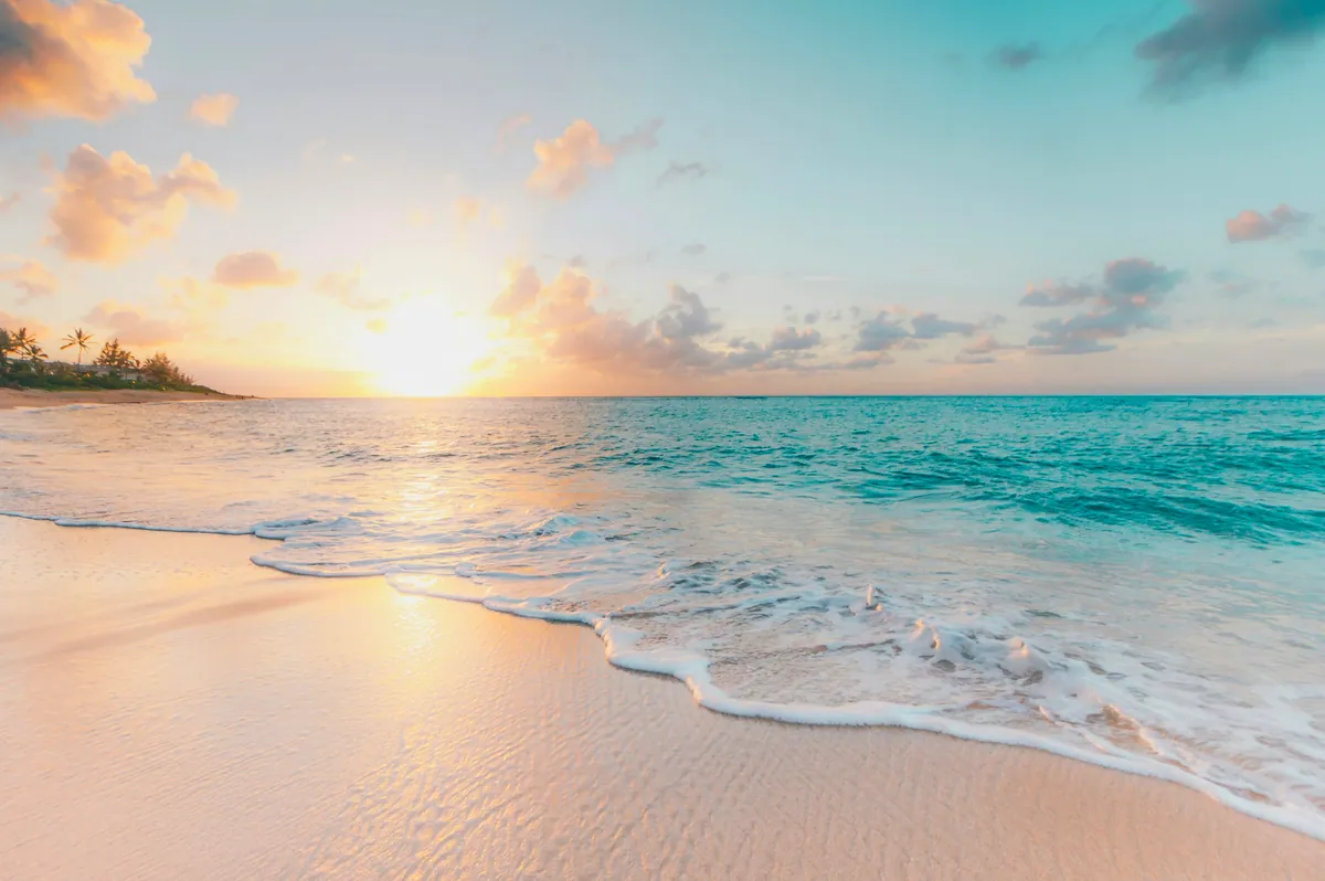 Caribbean beach at golden hour with turquoise water